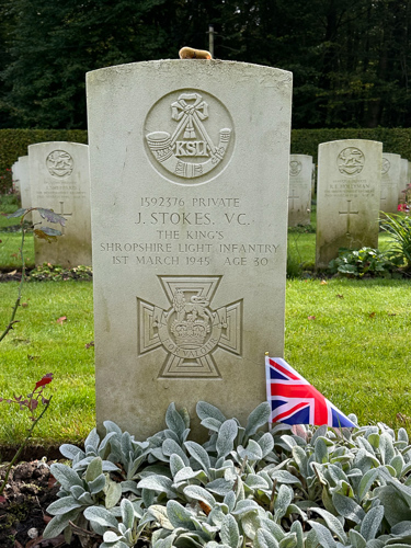 Headstone of Private J. Stokes VC. A small Union Jack has been left in tribute at the base of the CWGC headstone.