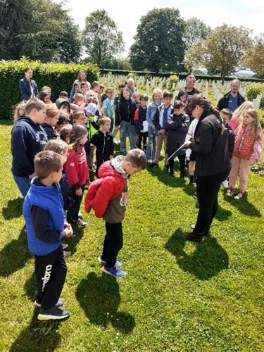 The pupils of Cintheaux visiting Bretteville-sur-Laize War Cemetery with Lucie Balin