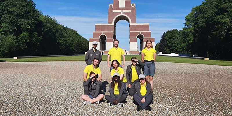A group of Commonwealth War Graves Guides poses in front of the Thiepval Memorial