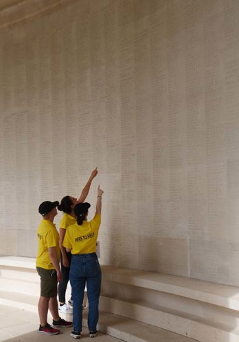 Commonwealth War Graves Guides view names on panels at the Arras Memorial