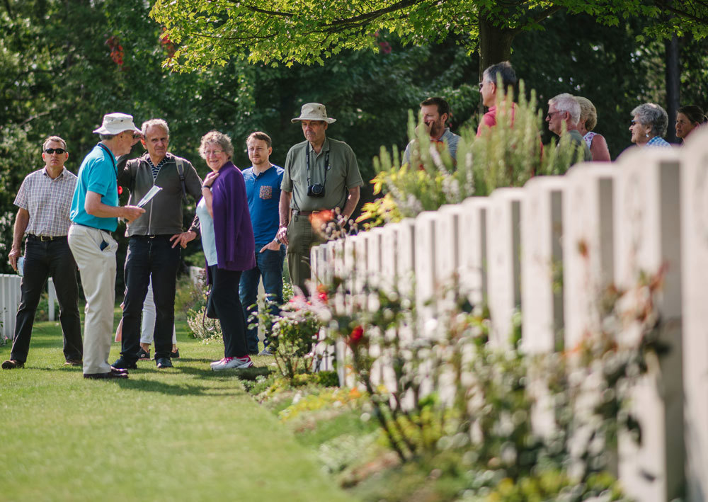 A volunteer conducting a tour in a CWGC cemetery.