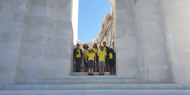 A group of Commonwealth War Graves Guides standing on the steps of the Vimy Memorial.