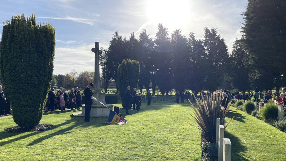 A standard bearer lowers his flag in remembrance of the fallen at Hakwinge Cemetery as part of the 2024 Remembrance Day ceremonies.