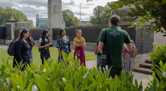 Visitors to Tower Hill Memorial listening to a CWGC tour guide.