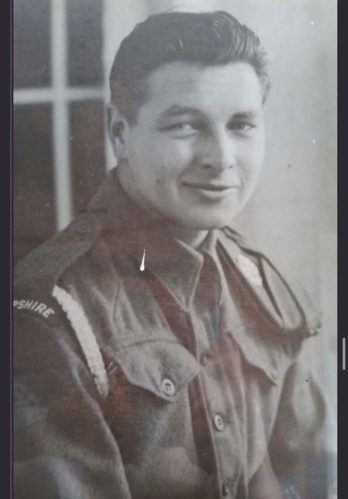 Black and white portrait photo of Private Graham Nye. He is wearing his military uniform with his unit badge clearly visible on his right sleeve.