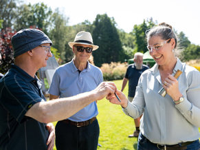 Visitors to a CWGC cemetery speak with one of the ground staff.