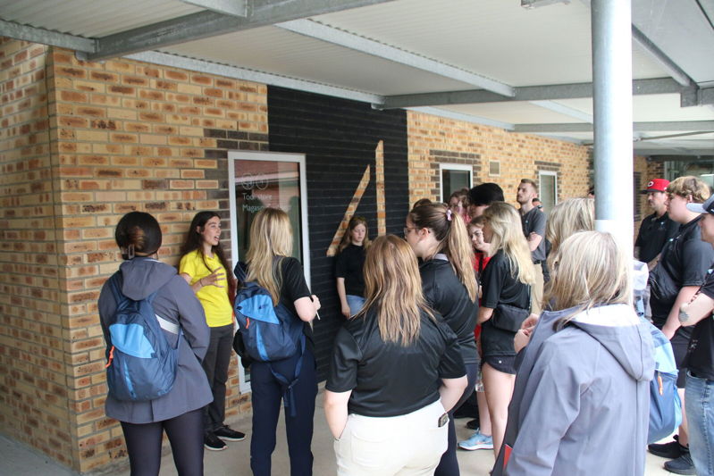 A CWGF Guide speaking to a group of secondary school age teenagers at the Commonwealth War Graves Visitor Centre.